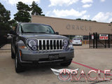 Three quarters view of a Jeep Liberty with white LED headlight halo rings installed.