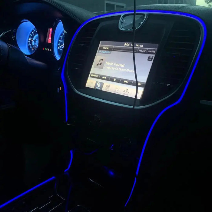 Close-up of blue fiber optic lighting installed on the console of a vehicle.