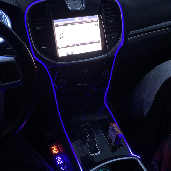 Close-up of blue fiber optic lighting installed on the console of a vehicle.