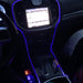 Close-up of blue fiber optic lighting installed on the console of a vehicle.