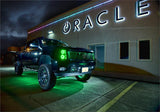 Three quarters view of a Chevrolet Silverado with green LED headlight halo rings installed.