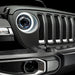Close-up on the front end of a Jeep Wrangler with Oculus Headlights installed, with white LED halos.
