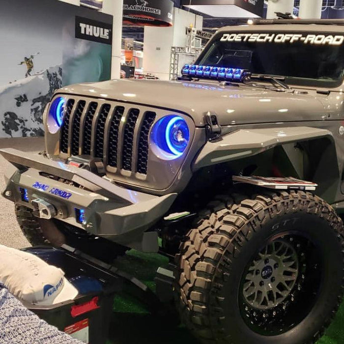 Three quarters view of a Jeep Gladiator JT in a showroom, with ColorSHIFT Oculus Headlights installed.