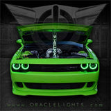 Front end of a green Dodge Challenger with green LED headlight halo rings installed.