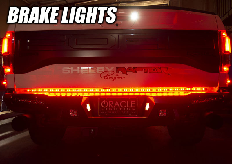 Rear view of a Ford Raptor with 60” Double Row LED Truck Tailgate Light Bar installed and brake lights on.