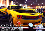 Chevrolet Camaro in a showroom with red LED headlight and fog light halo rings installed.