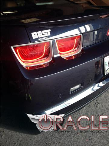 Close-up shot of a dark blue camaro with afterburner tail light halos