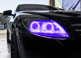 Close-up on the headlight of a Mercedes Benz CL 500 with purple LED halo rings.