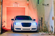 Front view of a Chrysler with white LED headlight halo rings.