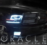 Front end of a black Dodge Ram with white LED headlight and fog light halo rings installed.