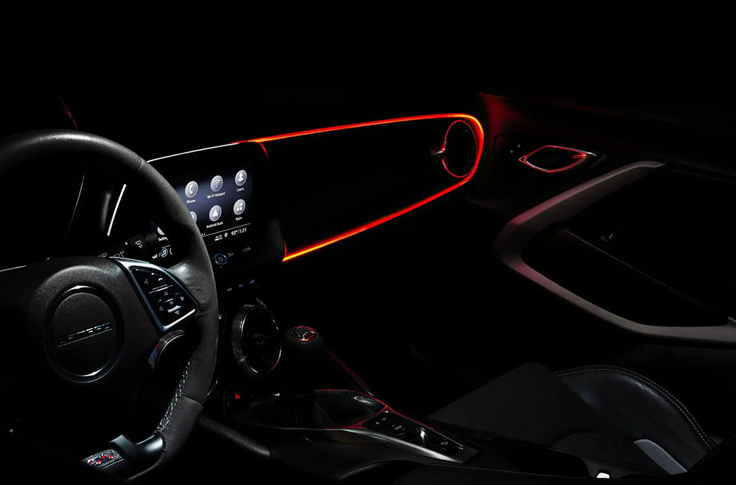 Car interior with red fiber optic lighting installed on the dashboard.
