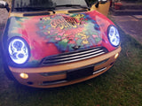 Front end of a Mini Cooper with white LED headlight halo rings installed.