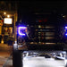 GMC sierra parked outside with purple DRLs