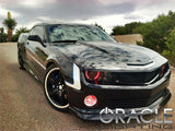 Three quarters view of a Chevrolet Camaro with red LED headlight and fog light halo rings installed.