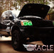 Three quarters view of a Nissan Titan with green LED headlight halo rings installed.