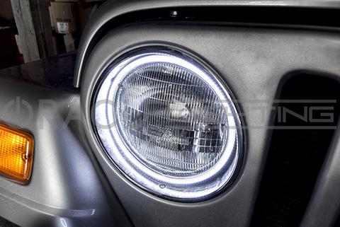 Close-up of white LED halo ring installed on a Jeep.