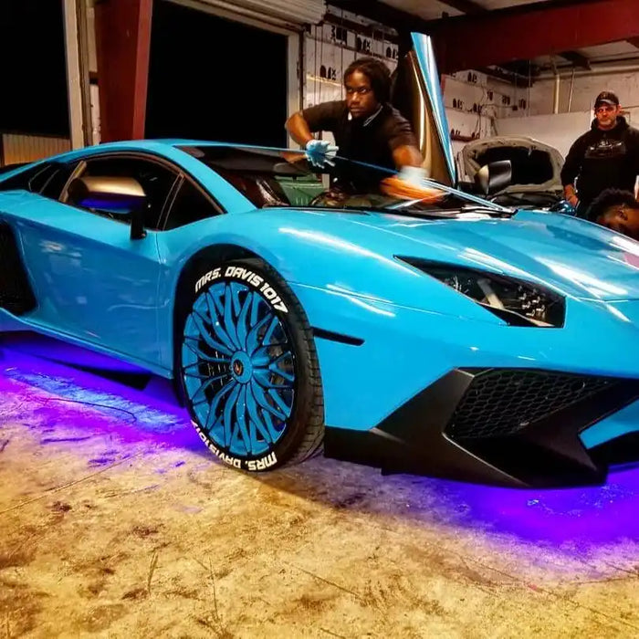 Blue Lamborghini with purple LED underbody kit.