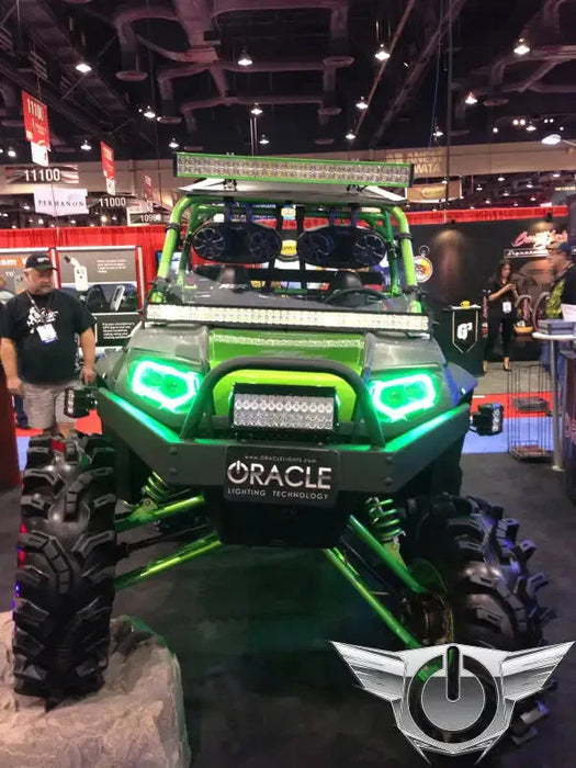 Polaris RZR in a showroom, equipped with green LED headlight halos.