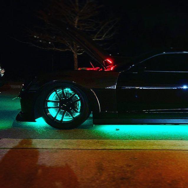 Side view of black Camaro with LED wheel rings and LED underbody kit installed.
