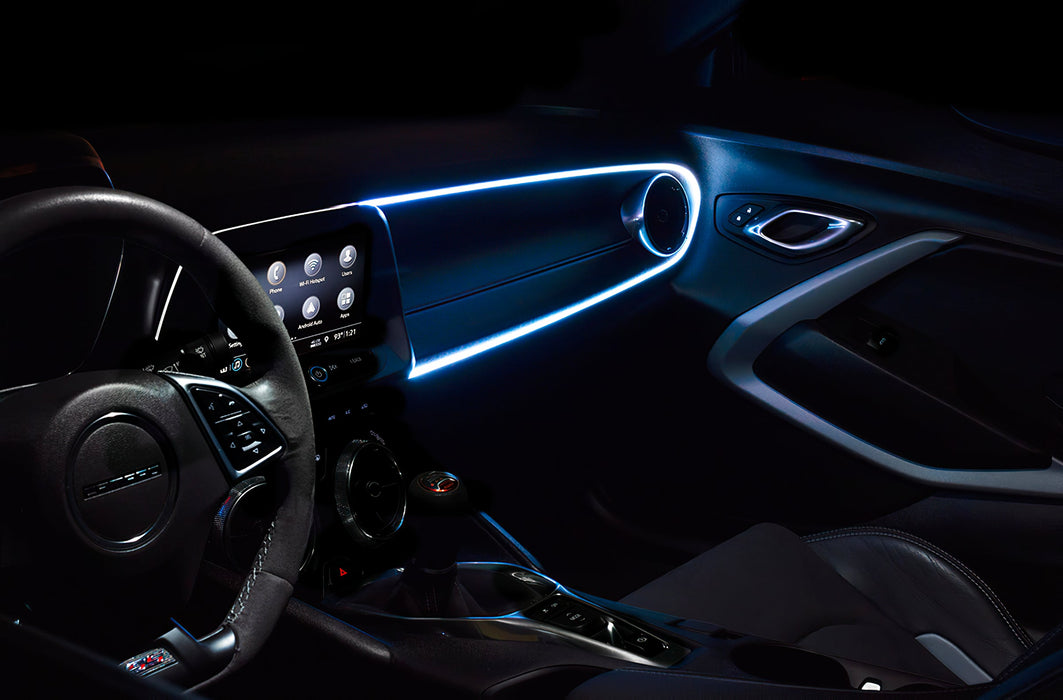 Car interior with white fiber optic lighting installed on the dashboard.