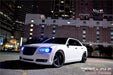 Three quarters view of a Chrysler with blue LED headlight halo rings installed.