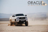 Toyota Tundra riding through the desert with white LED headlight halo rings installed.