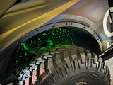 Close-up of fiber optic wheel liner kit installed on bronco with green LED lighting
