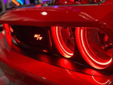 Close-up of challenger headlights with red halos