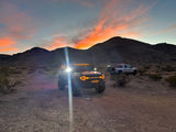 Bronco with amber LED lighting products in the desert with silver truck