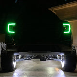 GMC sierra parked at night with green DRLs